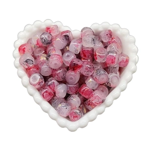 Pink and grey marble beads with gold flakes in a heart ceramic bowl for DIY jewelry