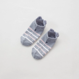 Detail of grey low-cut socks with 3D animal ears and striped patterns on white background