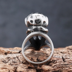 Vintage Viking raven skull stainless steel ring with rustic wood bark background