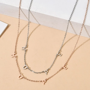 Minimalist stainless steel necklace featuring silver and rose gold HOPE letter pendants