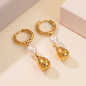 Fashionable gold hoop earrings with white pearl and teardrop pendant on neutral background