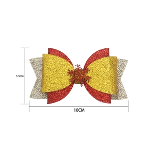Detail of a 10cm Christmas bow clip with red, gold glitter and snowflake ornament