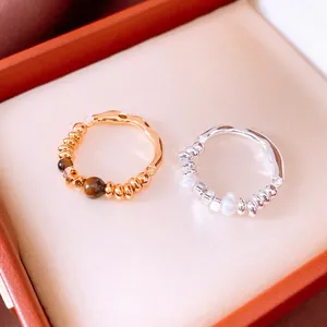 18K gold plated tiger eye and pearl wave rings displayed in a luxury orange jewelry box