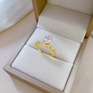 Elegant gold crown heart ring with clear zircons in a beige velvet jewelry box