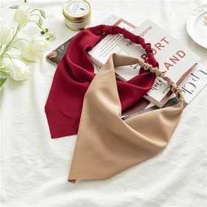 Flat lay of red and beige chiffon headbands with elastic bands and floral decor