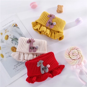 Three knitted kids' neck warmers with cute giraffe patches in yellow, beige, and red