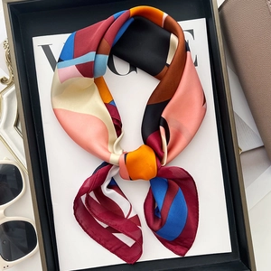 Elegant geometric silk neckerchief with colorful abstract print and glossy texture