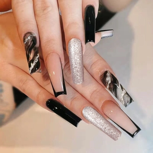Detail of long square press-on nails with black glossy finish and silver glitter accents