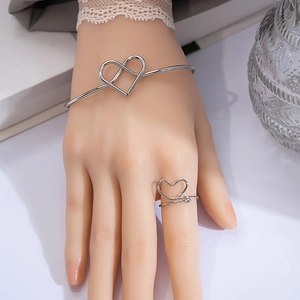 Minimalist silver heart-shaped open bangle and ring set with elegant polished metal finish