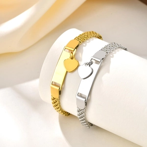 Detailed close-up of mesh bracelets with polished ID plates and small heart charms