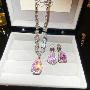 Pink teardrop gemstone necklace and earrings set in silver finish with pavé rhinestones