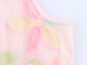 Detail of 3D mesh flowers with colorful sequins on a sweet pink high waist tulle dress
