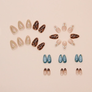 Detail view of leopard print and cat-eye nail set with 3D gold accents on pink background