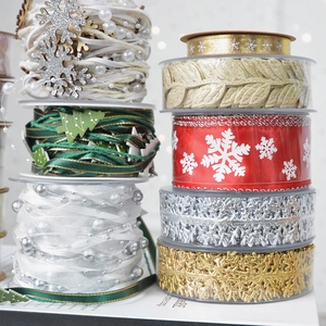 Assorted Christmas ribbons and bead chains with gold stars and snowflake patterns