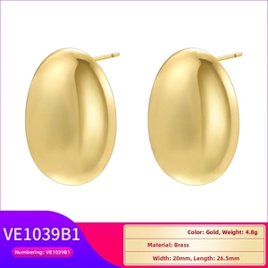 Macro detail of gold-plated brass teardrop earrings with dimensions and weight