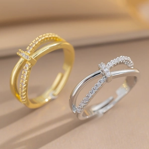 Luxurious criss-cross knot rings with pavé micro-diamonds in gold and silver finishes