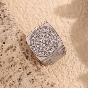Macro shot of silver men's signet ring with micro-paved rhinestones on textured stone