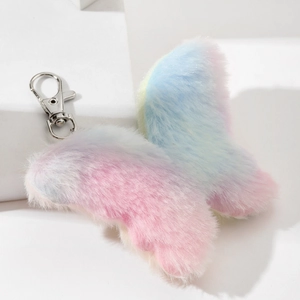 Detail showing plush rainbow butterfly keychain with soft faux fur and silver metal clasp