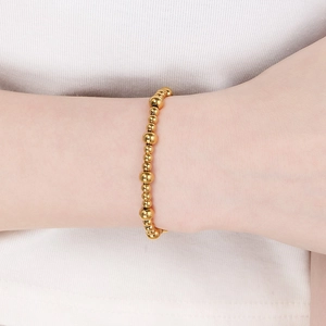 Minimalist 18K gold plated stainless steel bead bracelet shown on a woman's wrist