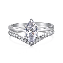 Macro view of marquise-cut stone ring with matching chevron silver band set