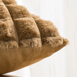 Brown faux rabbit fur throw pillow with checkered plush texture in a cozy setting