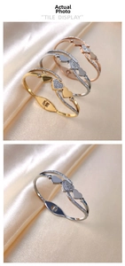 Detailed close-up of heart charm bracelets in gold, silver, and rose gold on silk