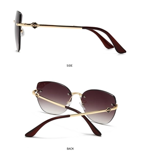 Detail view showing golden metal temples and brown gradient lenses of cat eye sunglasses
