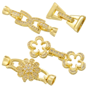 Macro shot of gold-plated flower and infinity-shaped jewelry clasps with zircon