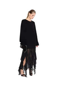 Detail of black knit sweater with irregular lace splicing and layered chiffon skirt texture