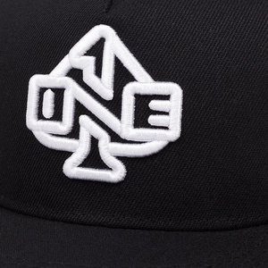 Detail of 3D embroidery showing white ONE logo on a black cotton baseball cap