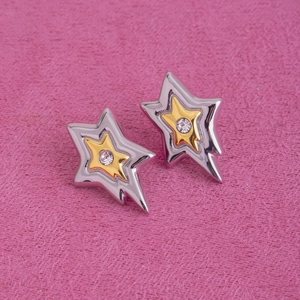 Détail de boucles d'oreilles en forme d'étoile en or et argent avec zircons clairs