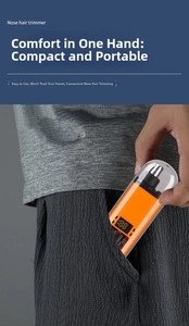 Macro detail of portable nose hair trimmer with digital display tucked into a pocket