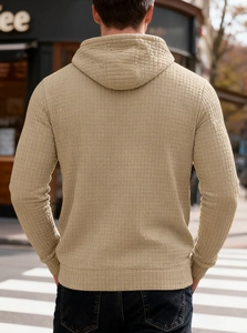 Detail of men's casual waffle knit hoodie in beige showing texture and hood structure