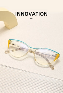 Detail view of cat-eye eyewear showing blue and yellow pattern on champagne frame