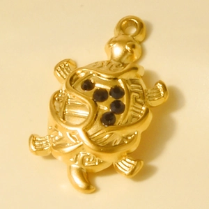 Close-up of 18k gold plated stainless steel turtle pendant with black crystals