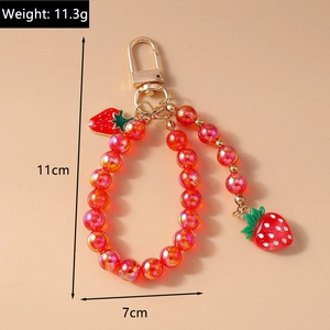Detail of red strawberry beaded keychain showing dimensions 11cm length and 11.3g weight