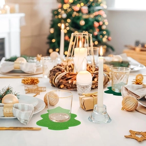 Detail of a green felt Christmas tree coaster on a decorated holiday dining table