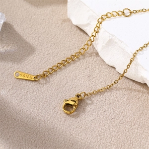 Detailed close-up of 18k gold plated lobster clasp and S.STEEL stamp on the extension chain