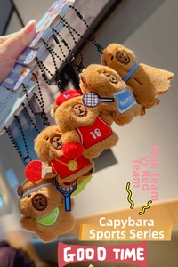 Close-up of five cute plush capybara keychains in various colorful sports outfits