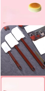 Detail view of seamless silicone spatula set with ergonomic brown handles for baking