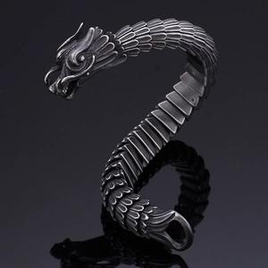 Macro shot of retro dragon scale texture and detailed head on stainless steel bracelet