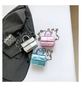 Three metallic mini crossbody bags in silver, pink and blue with glossy crocodile texture