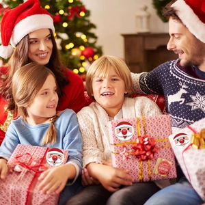 Family sharing Christmas gifts decorated with Santa Claus stickers in a warm home setting