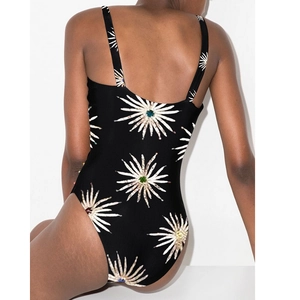 Detailed back view of one-piece swimsuit with white sunflower patterns and wide straps