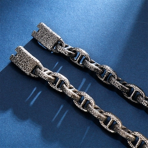 Detail of vintage anchor chain bracelet showing aged steel texture and sturdy toggle clasp