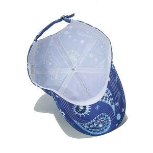 Detail view of paisley baseball cap featuring white mesh lining and metal buckle strap