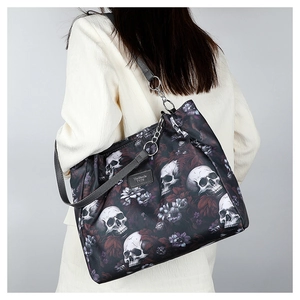Detail of floral skull pattern on large Oxford fabric tote bag worn by model