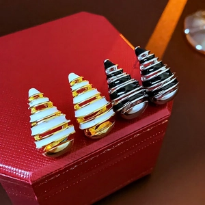 Vintage spiral gold and silver plated earrings with enamel finish on red jewelry box