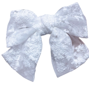 Elegant white lace bow hair clip with floral embroidery on clean white background