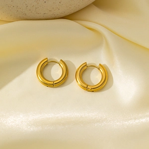 Polished 18k gold plated stainless steel 4mm thick hoop earrings on silk fabric